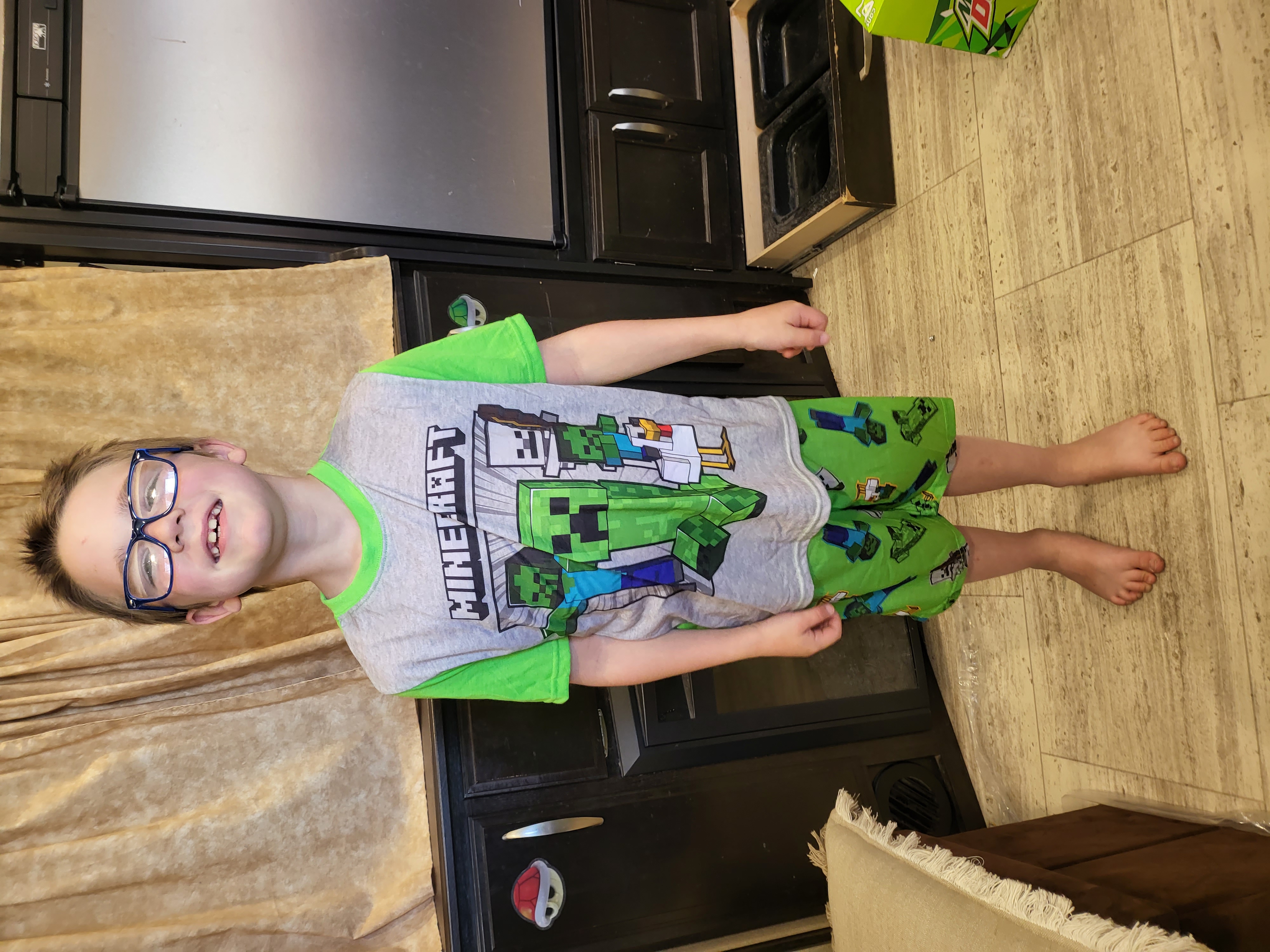 Aden smiling in Minecraft pajamas inside the RV in Elm Mott, Texas.