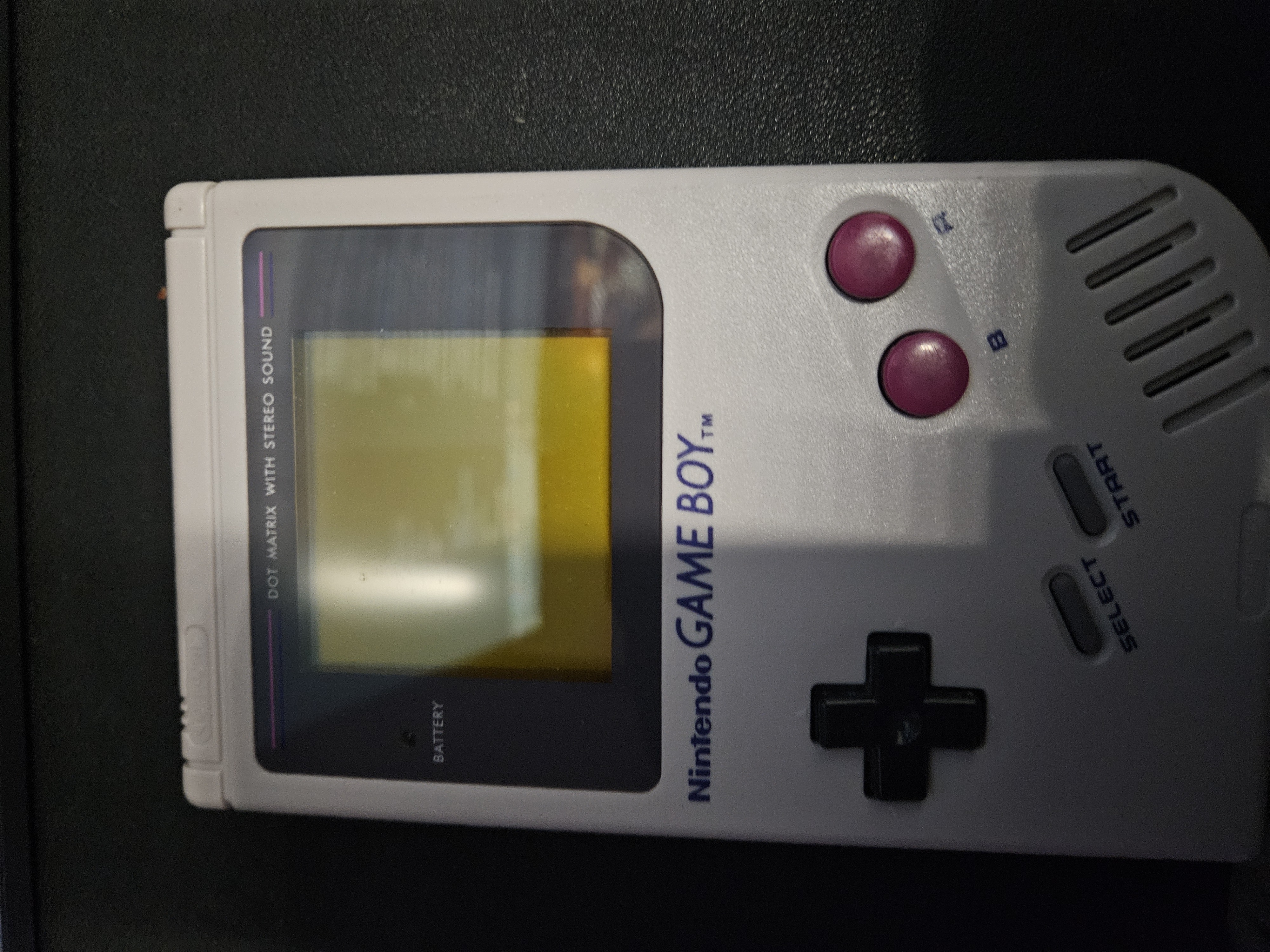 A classic Nintendo Game Boy handheld in good condition.