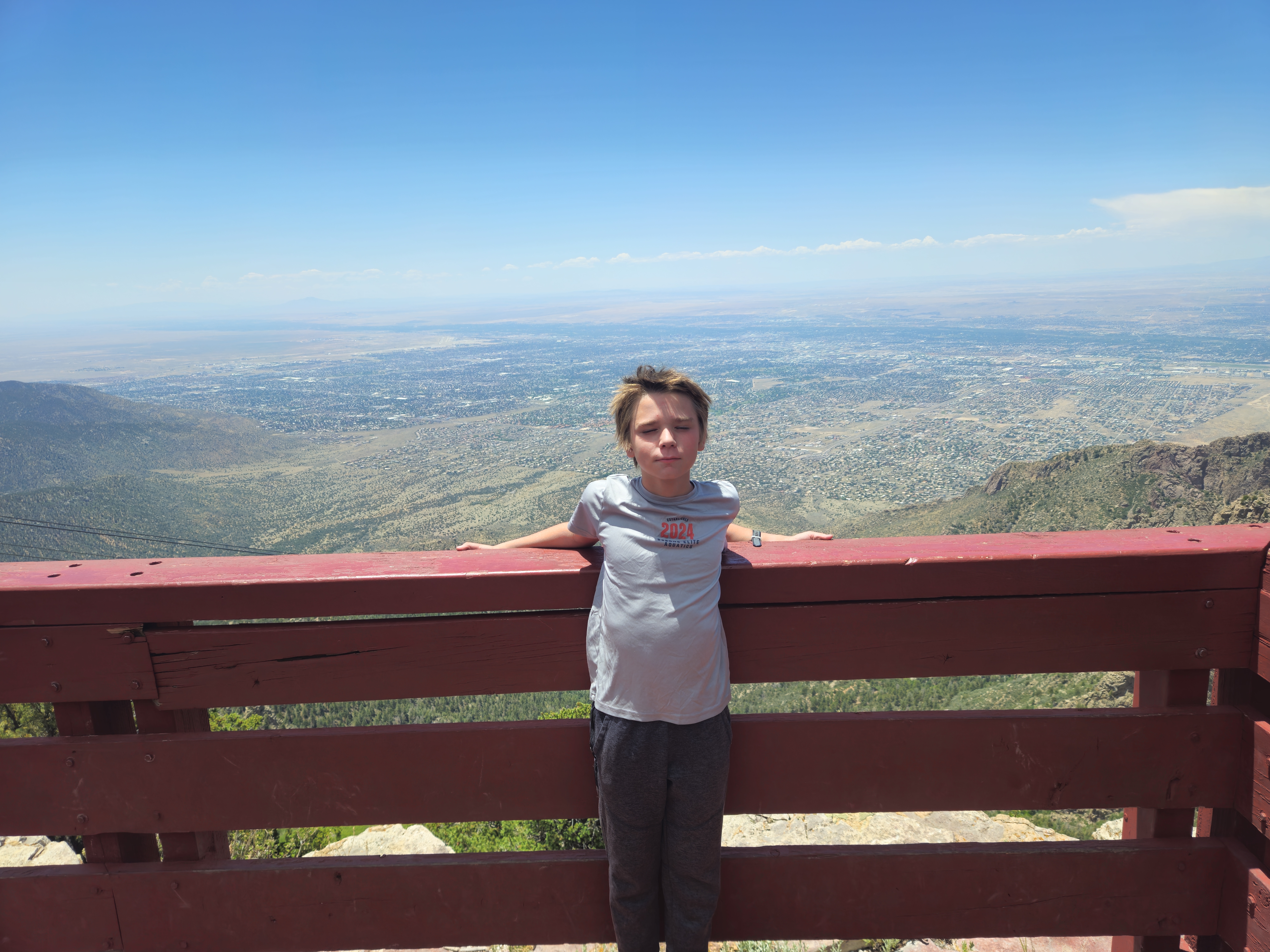Aden standing at an overlook above Albuquerque after a bike ride.
